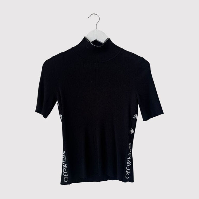 Black turtleneck shirt on a hanger against a white background