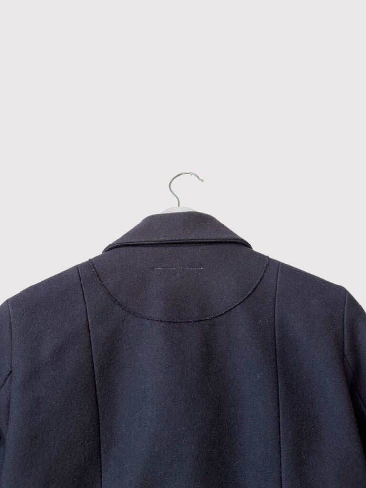 
                  
                    Upper back detail of Maison Margiela Snaps Wool Grommet jacket, emphasizing curved seam and high-quality wool craftsmanship.
                  
                