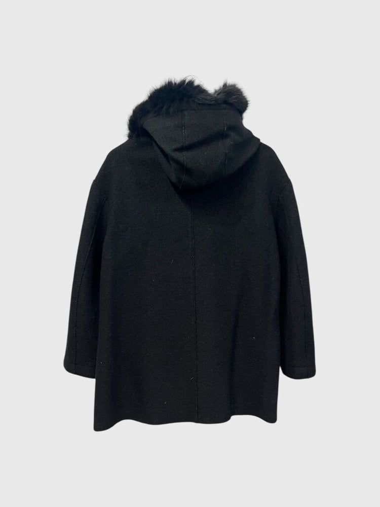 Black coat with fur hood on a light gray background