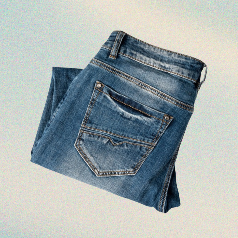 Folded pair of blue jeans on a light gradient background